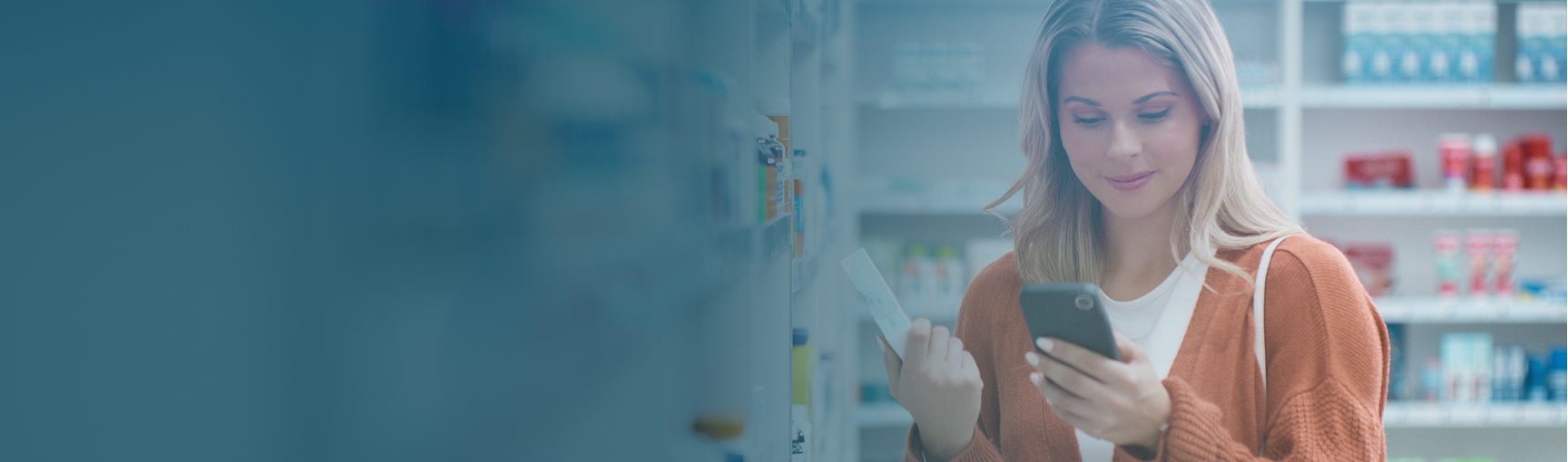 Woman using phone in pharmacy