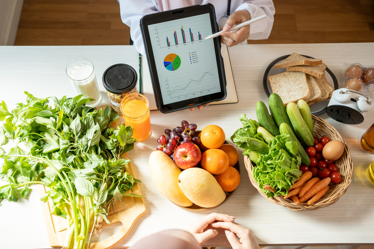 Patient of nutritionist in front of health and wellness doctor